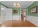 Elegant dining room with crown molding, decorative lighting, and double French doors to living room and kitchen at 804 Warwick Ct, Burlington, NC 27215