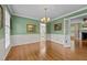 Charming dining room with wainscoting, classic chandelier, and French doors leading to the living spaces at 804 Warwick Ct, Burlington, NC 27215