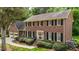 Beautiful brick home with black shutters, well-manicured landscaping, and a charming entrance at 804 Warwick Ct, Burlington, NC 27215