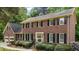 Charming brick home featuring black shutters, well-kept landscaping, and a welcoming front entrance at 804 Warwick Ct, Burlington, NC 27215