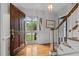 Inviting foyer with hardwood floors, staircase, and natural light streaming through the glass-paned front door at 804 Warwick Ct, Burlington, NC 27215
