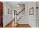 Elegant foyer featuring hardwood floors, staircase with white railings, and traditional decor at 804 Warwick Ct, Burlington, NC 27215