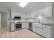 Modern kitchen with stainless steel appliances, white cabinets, granite countertops, and tile flooring at 804 Warwick Ct, Burlington, NC 27215