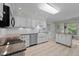 Well-lit kitchen featuring white cabinets, stainless steel appliances, and granite countertops, perfect for cooking at 804 Warwick Ct, Burlington, NC 27215