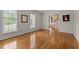 Light-filled living room featuring hardwood floors, bright windows, and an open doorway to the foyer at 804 Warwick Ct, Burlington, NC 27215