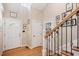 Welcoming foyer with hardwood floors and staircase with a wooden handrail and decorative iron spindles at 829 Joyner Ct, Wake Forest, NC 27587