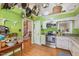 Kitchen with stainless steel appliances, granite countertops, and a view of a staircase and hall at 829 Joyner Ct, Wake Forest, NC 27587