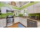 Charming kitchen with stainless steel appliances, granite countertops and bright green walls at 829 Joyner Ct, Wake Forest, NC 27587