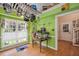 Bright kitchen with stainless steel pans hanging, large window, wood floors and granite countertops at 829 Joyner Ct, Wake Forest, NC 27587