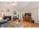 Comfortable living room featuring a brick fireplace, hardwood floors, and plenty of natural light at 829 Joyner Ct, Wake Forest, NC 27587