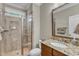 Bathroom with tiled walk-in shower, granite countertop, and framed mirror at 1012 Wandering Way, Rolesville, NC 27571