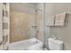 Tiled shower and tub combination with a shower head, accompanied by a toilet and towel rack in this bathroom at 1012 Wandering Way, Rolesville, NC 27571