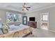 Well-lit bedroom with a large window, a full-length mirror, and a view into the ensuite bathroom with a tub at 1012 Wandering Way, Rolesville, NC 27571