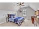 Attic bedroom with a ceiling fan, comfortable bed, two shelves and a window that provides natural light at 1012 Wandering Way, Rolesville, NC 27571