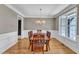 Formal dining room with hardwood floors, chandelier lighting and natural light from a window at 1012 Wandering Way, Rolesville, NC 27571