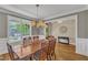Dining room with hardwood floors, chandelier lighting, and abundant natural light from a window at 1012 Wandering Way, Rolesville, NC 27571