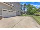 Spacious driveway leading to a two-car garage and a well-maintained backyard at 1012 Wandering Way, Rolesville, NC 27571
