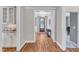 Hallway with hardwood floors leading to front door and adjacent rooms at 1012 Wandering Way, Rolesville, NC 27571