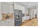 Modern kitchen featuring stainless steel appliances, granite countertops, and white cabinetry at 1012 Wandering Way, Rolesville, NC 27571