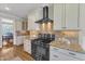 Stylish kitchen with granite countertops, stainless steel appliances, and a modern range hood at 1012 Wandering Way, Rolesville, NC 27571