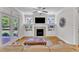 Bright living room features built-in shelves, fireplace, and natural light from french doors at 1012 Wandering Way, Rolesville, NC 27571