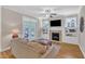 Cozy living room with built-in shelving, a fireplace, and french doors leading to the outdoors at 1012 Wandering Way, Rolesville, NC 27571