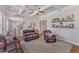 Spacious living room with hardwood floors, coffered ceiling, decorative shelves, and large windows at 1012 Wandering Way, Rolesville, NC 27571