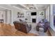 Cozy living room with hardwood floors, coffered ceiling, fireplace, and lots of natural light at 1012 Wandering Way, Rolesville, NC 27571