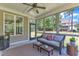 Cozy screened porch with comfortable seating, ceiling fan, and views of the private backyard at 1012 Wandering Way, Rolesville, NC 27571