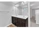 Bathroom featuring double vanity with storage and a large mirror, complemented by modern fixtures and finishes at 1013 Fieldmere Pl, Wendell, NC 27591