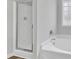 Bathroom featuring glass-enclosed shower, garden tub, and natural light window at 1013 Fieldmere Pl, Wendell, NC 27591
