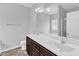 Bathroom featuring double sinks, a large mirror, and a glass enclosed shower at 1013 Fieldmere Pl, Wendell, NC 27591