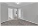 This bedroom features gray walls, gray carpet and access to two other rooms at 1013 Fieldmere Pl, Wendell, NC 27591