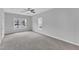 Bright bedroom featuring two windows, neutral carpet, and ceiling fan at 1013 Fieldmere Pl, Wendell, NC 27591