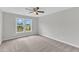 A bedroom featuring neutral colors and a ceiling fan for comfort, with a view through a double window at 1013 Fieldmere Pl, Wendell, NC 27591