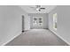 Bedroom with neutral carpet, two windows, ceiling fan, and white trim at 1013 Fieldmere Pl, Wendell, NC 27591