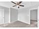 A comfortable bedroom with ceiling fan, carpet, and closet, creating a relaxing space with ample natural light at 1013 Fieldmere Pl, Wendell, NC 27591