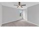 This cozy bedroom features carpet, a ceiling fan, and a window, perfect for relaxing or working from home at 1013 Fieldmere Pl, Wendell, NC 27591