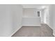 Upstairs bonus room offers extra living space with neutral paint, carpeting and bright natural light at 1013 Fieldmere Pl, Wendell, NC 27591