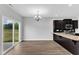 Bright dining area with sliding glass doors leading to the backyard, complemented by a modern chandelier at 1013 Fieldmere Pl, Wendell, NC 27591