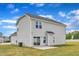 Back exterior view of the home with a patio and grassy lawn at 1013 Fieldmere Pl, Wendell, NC 27591