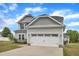 Charming two-story home with a two-car garage, light gray siding, and a well-manicured lawn at 1013 Fieldmere Pl, Wendell, NC 27591