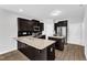 Elegant kitchen featuring granite countertops, stainless steel appliances, and dark wood cabinetry at 1013 Fieldmere Pl, Wendell, NC 27591