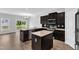 Modern kitchen with stainless appliances, granite counters, a kitchen island and an adjacent dining area at 1013 Fieldmere Pl, Wendell, NC 27591