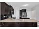 Modern kitchen with granite countertops, stainless steel appliances, dark cabinetry, and a stylish backsplash at 1013 Fieldmere Pl, Wendell, NC 27591