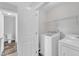 Bright laundry room featuring new appliances and convenient shelving for storage solutions and organization at 1013 Fieldmere Pl, Wendell, NC 27591