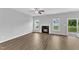 Spacious living room with a fireplace, wood floors, and a sliding glass door to the backyard at 1013 Fieldmere Pl, Wendell, NC 27591