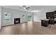 Open-concept living room with a fireplace, dark cabinets, and sliding glass doors at 1013 Fieldmere Pl, Wendell, NC 27591