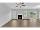 Bright living room featuring a fireplace, wood floors, and a ceiling fan at 1013 Fieldmere Pl, Wendell, NC 27591