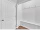 Bright mudroom featuring a built-in bench, white walls, and coat hooks at 1013 Fieldmere Pl, Wendell, NC 27591